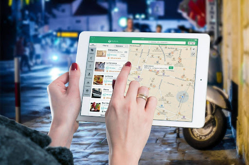 Tablet displaying local business search results with Google Business Profile listings, reviews, and map locations.